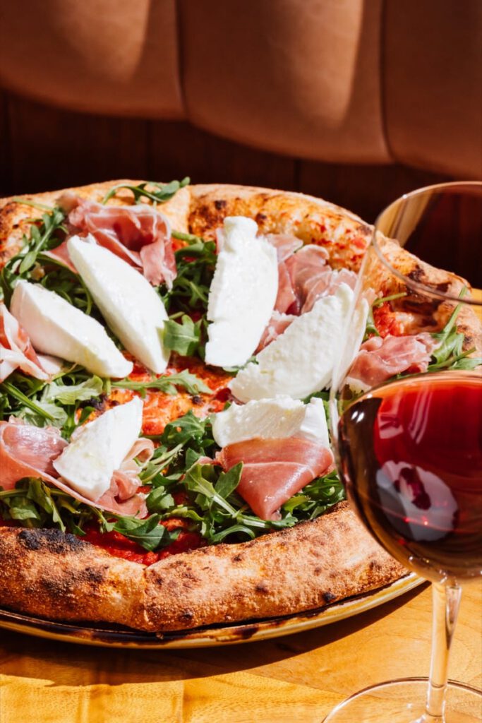 Wood-fired prosciutto pizza with fresh mozzarella and rocket at Il Verde Italian restaurant on King Street in Bowen Hills Brisbane