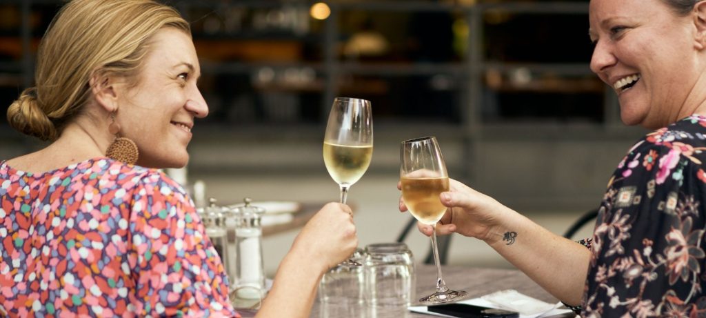 Two women enjoying white wine at Il Verde Italian restaurant on King Street in Bowen Hills Brisbane